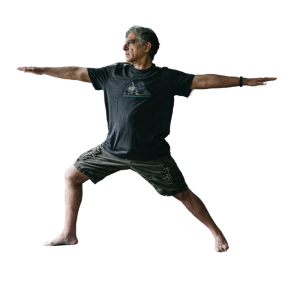 Man doing yoga pose with arms extended and legs in a lunge position.